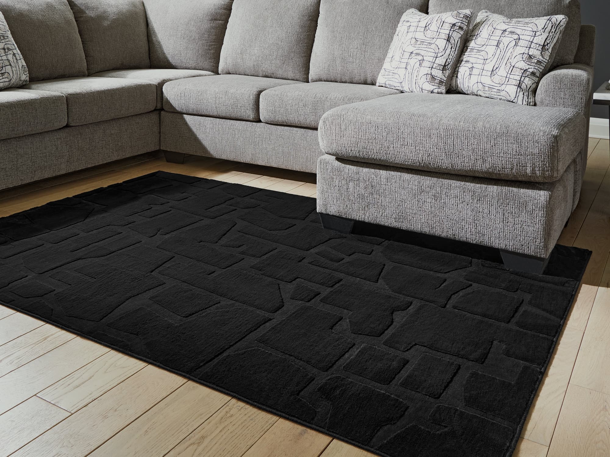 Gibbswell Black Washable 5' x 7' Area Rug - Image 1